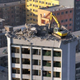 Illustration for article titled Why Is This Excavator Excavating A 12-Story Building From The Top Down?